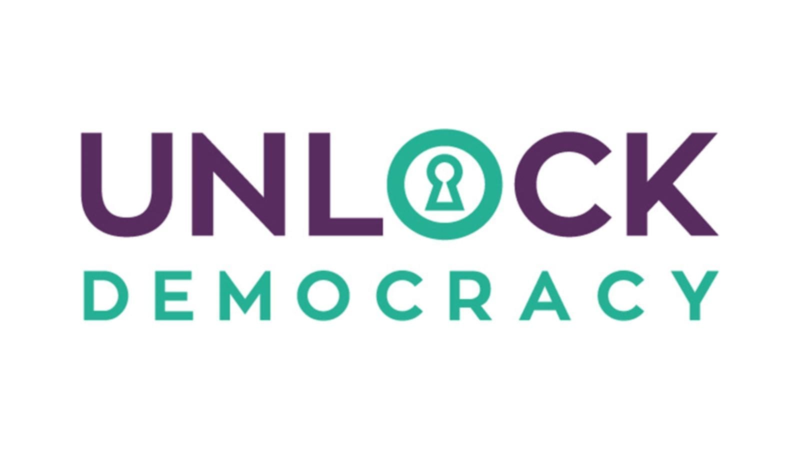 The word "UNLOCK" in purple apart from the "O" which is in turquoise. Under this is the word "Democracy" in turquoise.